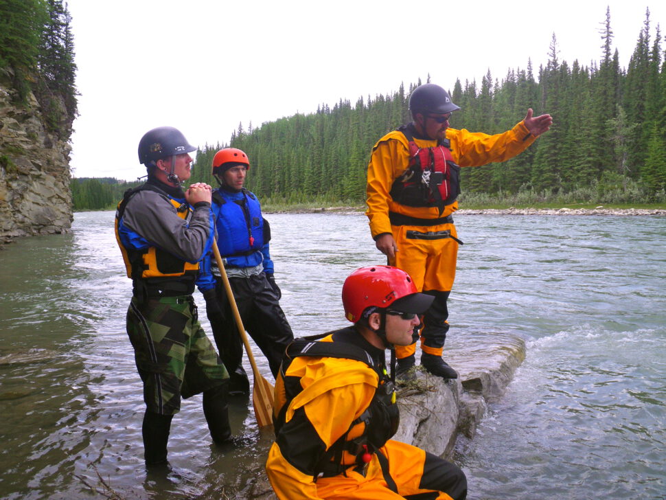 Students learn about how to read whitewater on an intermediate moving water course with Priscilla Haskin on the Red Deer River, AB.